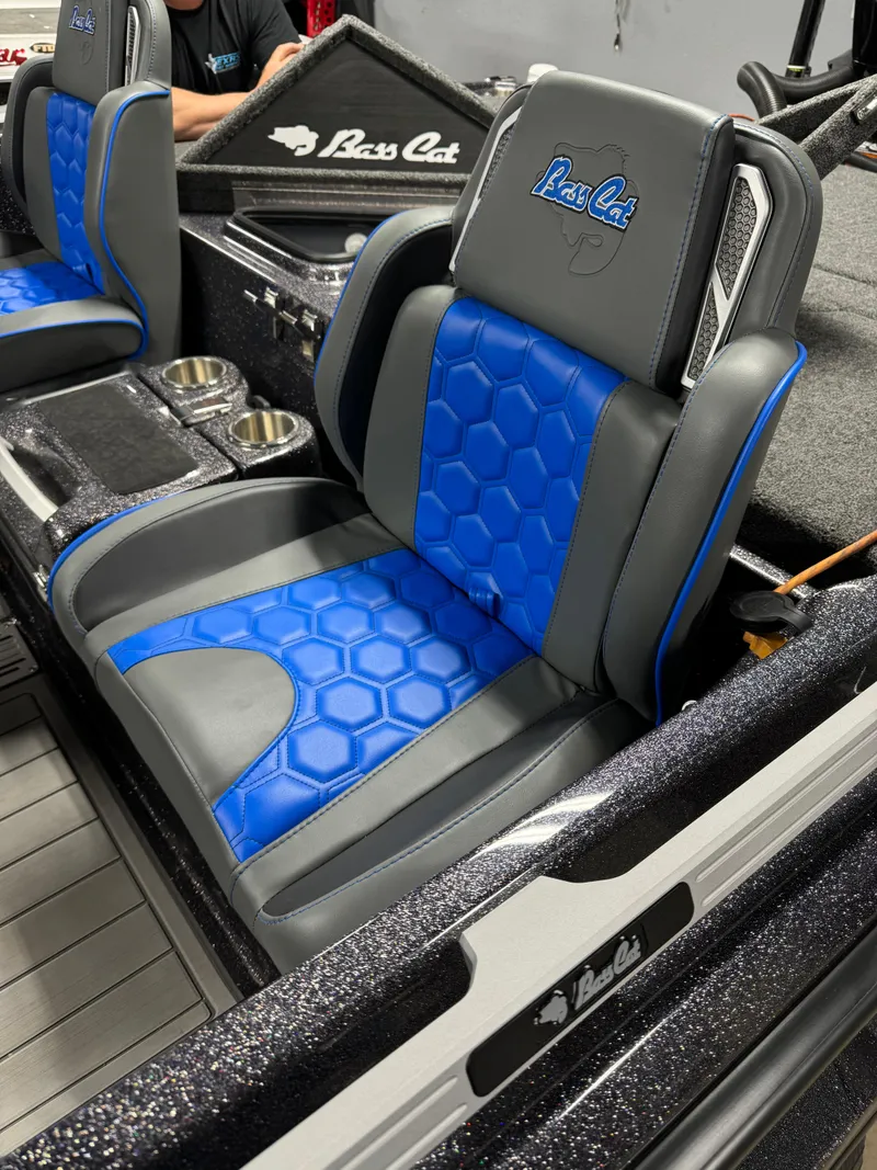 Slide: The Image of 2026 Bass Cat Lynx STS boat seat with blue and gray hexagonal pattern design. - 14
