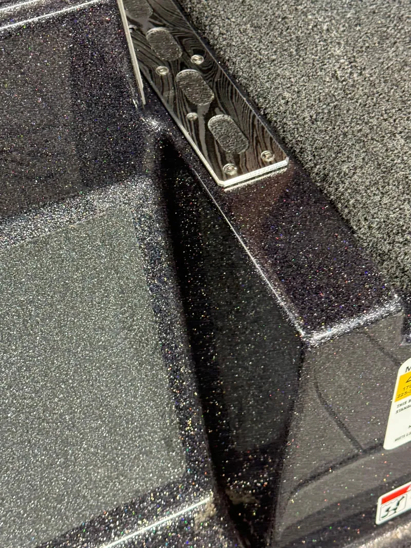 Slide: The Image of 2026 Bass Cat Lynx STS boat interior with textured surfaces and metal accents. - 16