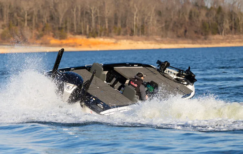 Slide: The Image of 2026 Bass Cat Lynx STS boat speeding on a lake, creating splashes. - 3