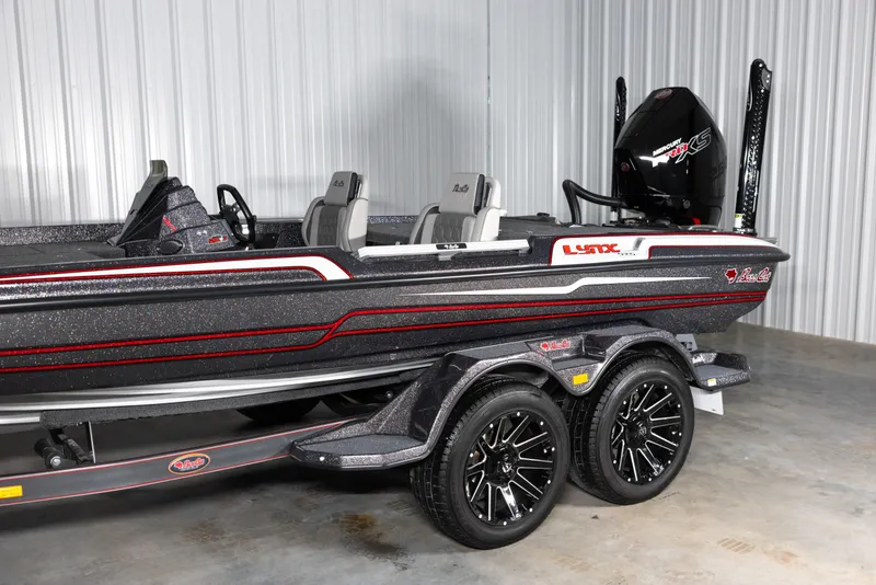 Slide: The Image of 2026 Bass Cat Lynx STS boat with sleek design and modern features in a showroom. - 4