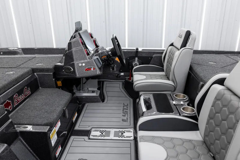 Slide: The Image of 2026 Bass Cat Lynx STS boat interior with modern dashboard and comfortable seating. - 5