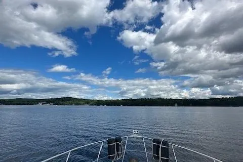 Slide: The Image of Bow of 2001 Carver 350 Mariner on a lake under a cloudy sky. - 13