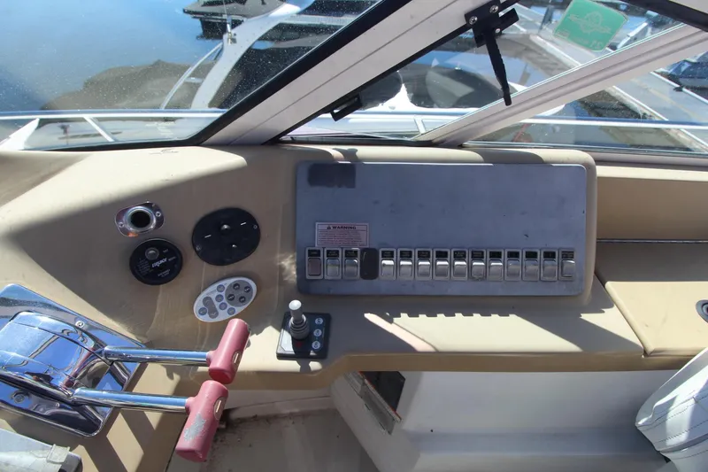 Slide: The Image of Control panel of a 2001 Carver 350 Mariner boat with switches and levers. - 5