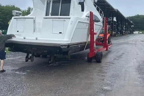 Slide: The Image of 2001 Carver 350 Mariner being transported on a red trailer at a marina. - 11