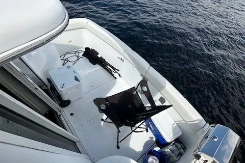 Slide: The Image of 2001 Carver 350 Mariner boat deck with chair, cooler, and ocean view. - 14