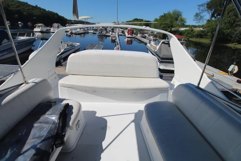 Slide: The Image of 2001 Carver 350 Mariner boat interior with white seating at a marina. - 6
