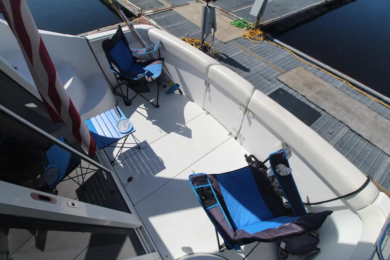 Slide: The Image of 2001 Carver 350 Mariner deck with folding chairs and dock view. - 7