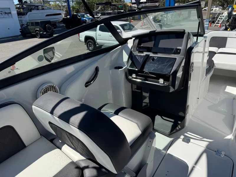 Slide: The Image of Interior view of a 2020 Monterey M-65 boat, featuring sleek seating and modern controls. - 33