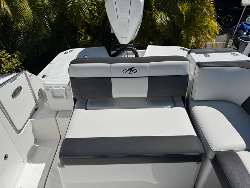 Slide: The Image of 2020 Monterey M-65 boat interior with cushioned seating and sleek design. - 47