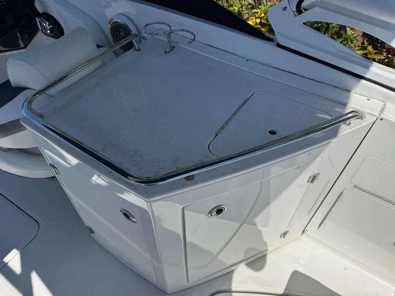 Slide: The Image of 2020 Monterey M-65 boat interior with sleek white cabinetry and cup holders. - 49