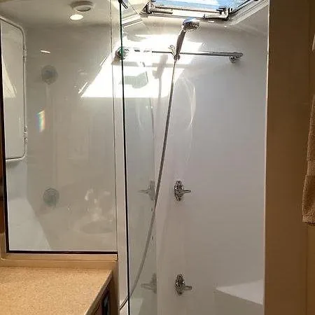Slide: The Image of Modern shower area in 2017 Tides 45 Sportfish boat with glass door and overhead light. - 12