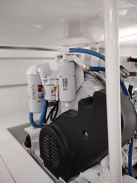 Slide: The Image of Engine room of 2017 Tides 45 Sportfish boat, showcasing mechanical components and filters. - 15