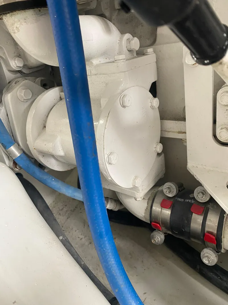 Slide: The Image of Engine compartment of 2017 Tides 45 Sportfish with visible blue hose and mechanical components. - 16