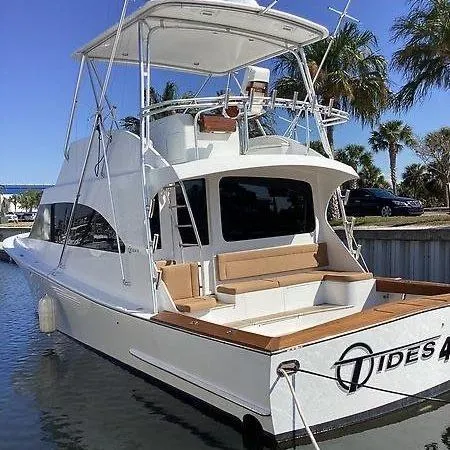 Slide: The Image of 2017 Tides 45 Sportfish boat docked, featuring spacious seating and sleek design. - 2