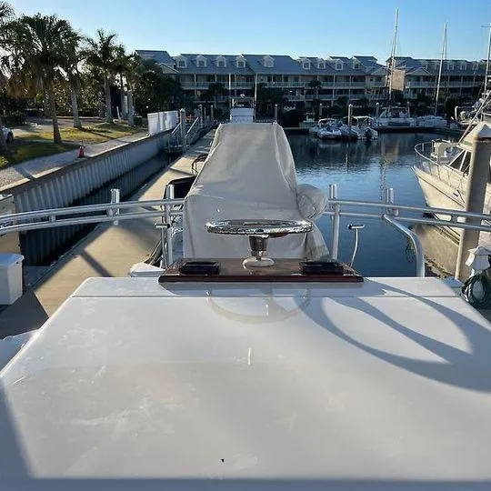 Slide: The Image of 2017 Tides 45 Sportfish yacht docked at marina with scenic waterfront view. - 22