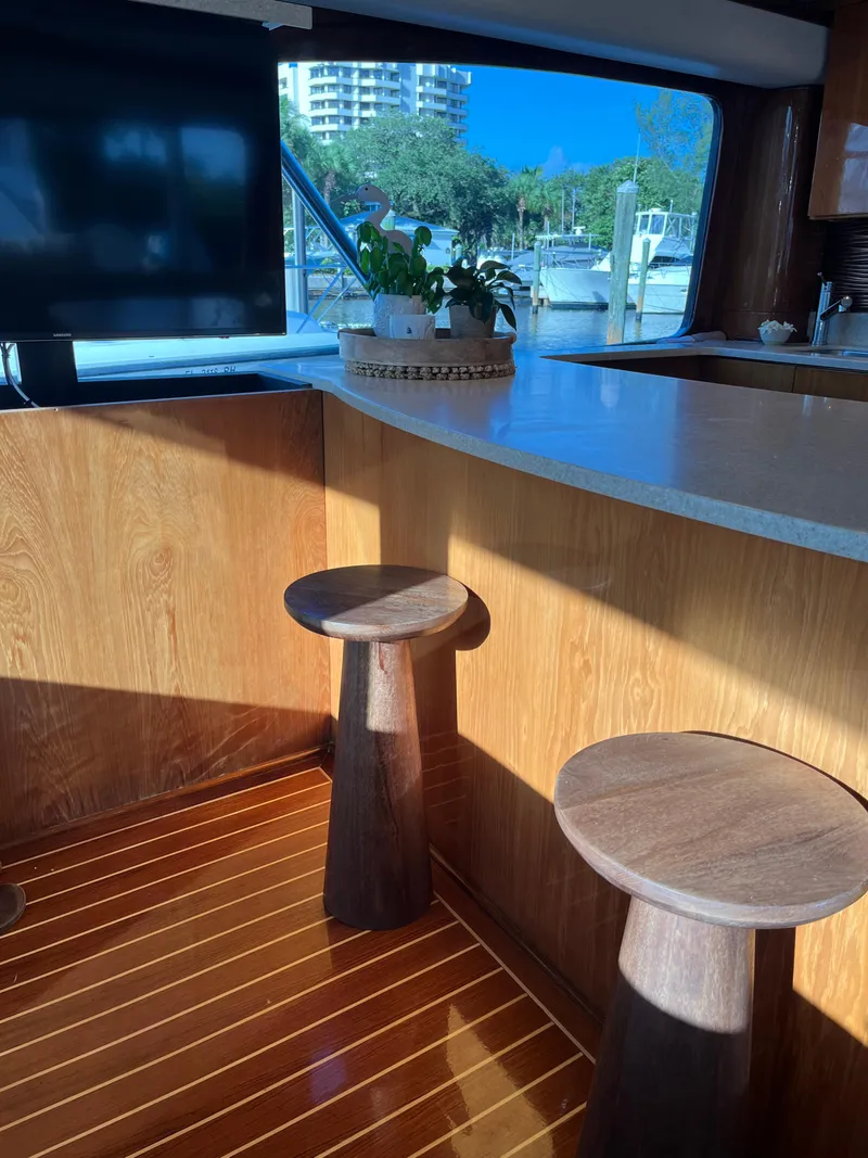Slide: The Image of Interior of 2017 Tides 45 Sportfish yacht with wooden stools and countertop. - 7