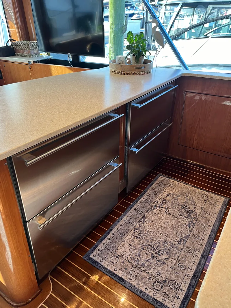 Slide: The Image of 2017 Tides 45 Sportfish yacht interior with modern kitchen and stainless steel appliances. - 8