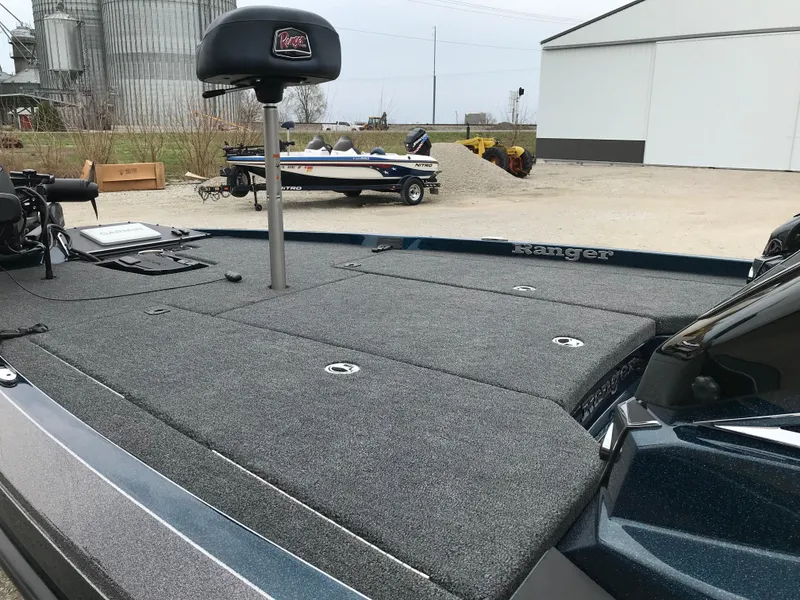 Slide: The Image of 2025 Ranger Z519 Garmin Ranger Cup boat on trailer, farm equipment in background. - 7