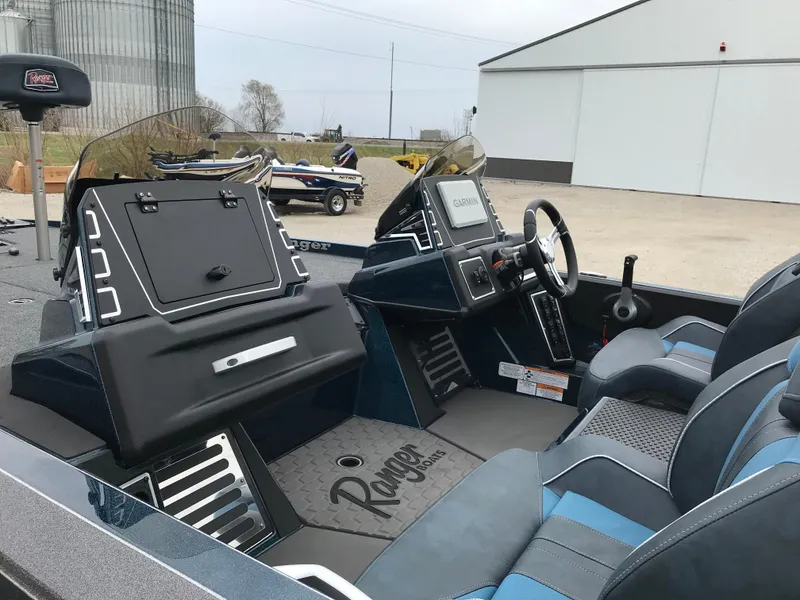 Slide: The Image of 2025 Ranger Z519 Garmin Ranger Cup boat interior with blue and gray seats. - 9