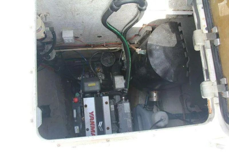 Slide: The Image of Engine compartment of 1995 Voyage Yachts Mayotte, featuring Yanmar engine and various components. - 15