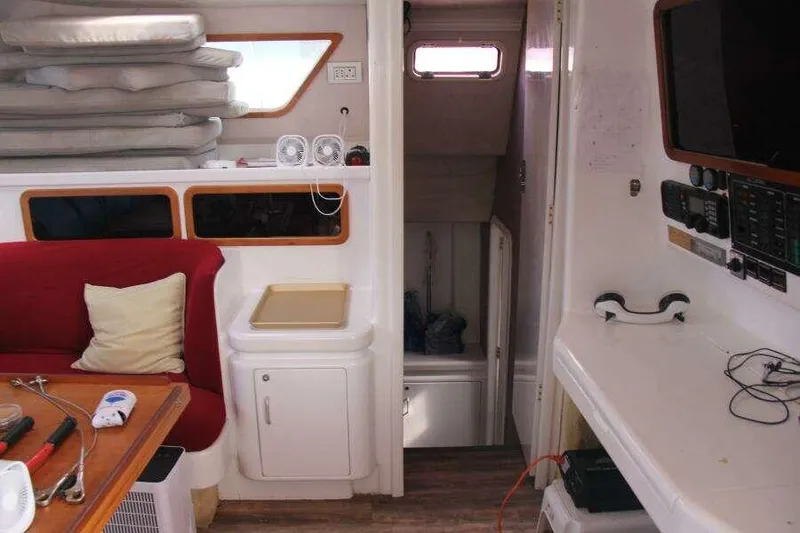 Slide: The Image of Interior of 1995 Voyage Yachts Mayotte, featuring seating, navigation equipment, and storage. - 16