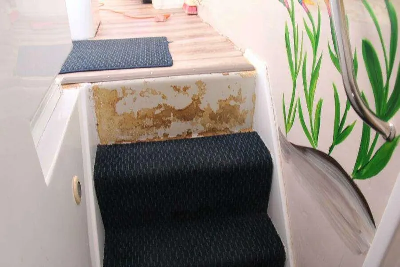 Slide: The Image of Staircase inside 1995 Voyage Yachts Mayotte, featuring carpet and decorative wall art. - 18