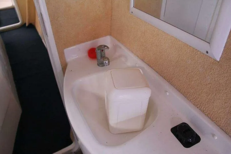 Slide: The Image of Sink area in 1995 Voyage Yachts Mayotte, featuring faucet and mirror. - 20