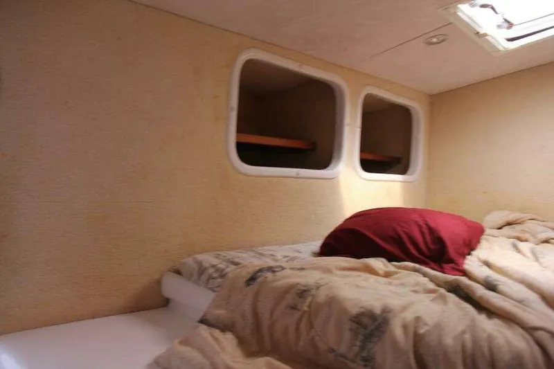 Slide: The Image of Cozy cabin interior of 1995 Voyage Yachts Mayotte with bed and portholes. - 21