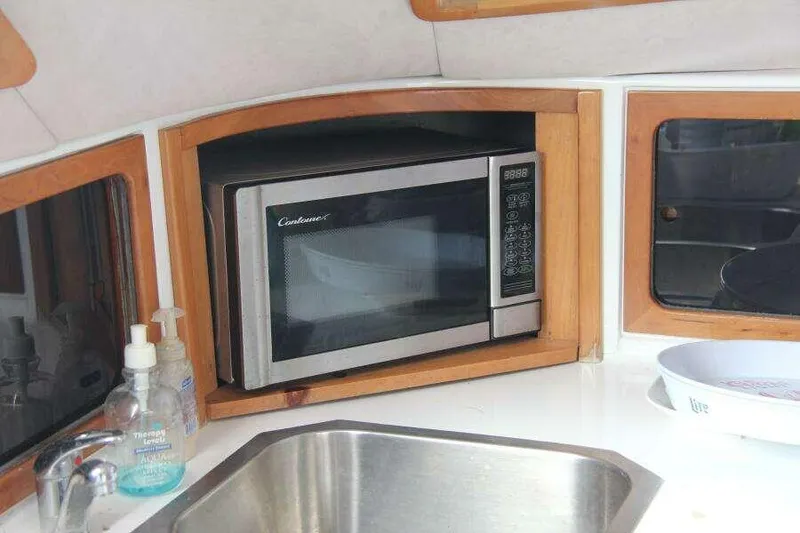 Slide: The Image of Microwave in 1995 Voyage Yachts Mayotte kitchen with sink and soap dispensers. - 27