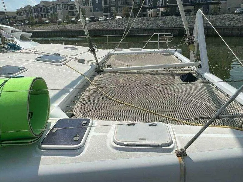 Slide: The Image of Catamaran deck of 1995 Voyage Yachts Mayotte with netting and green equipment. - 3