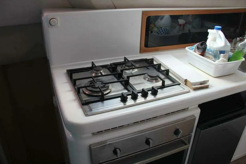 Slide: The Image of 1995 Voyage Yachts Mayotte kitchen with gas stove and countertop essentials. - 30