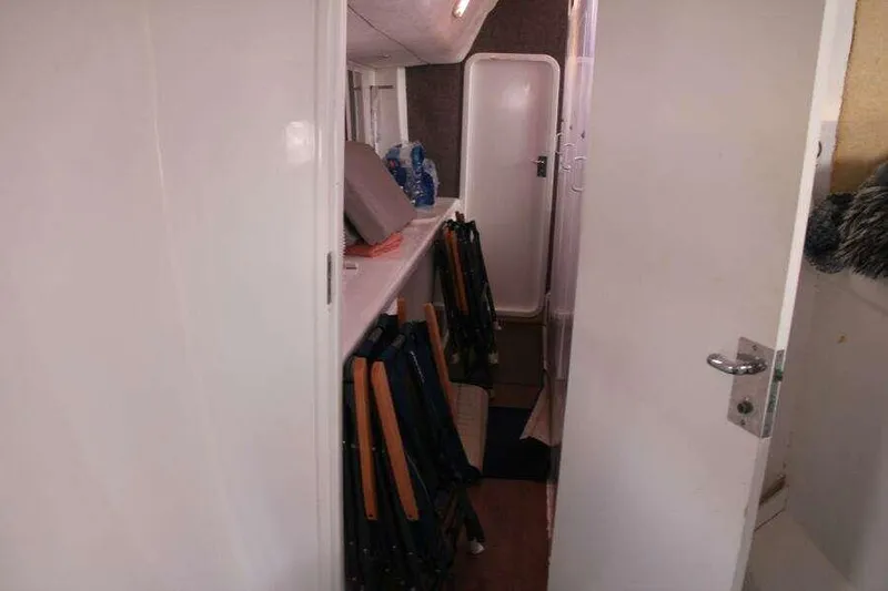 Slide: The Image of Interior view of 1995 Voyage Yachts Mayotte, featuring a narrow passageway and storage area. - 33