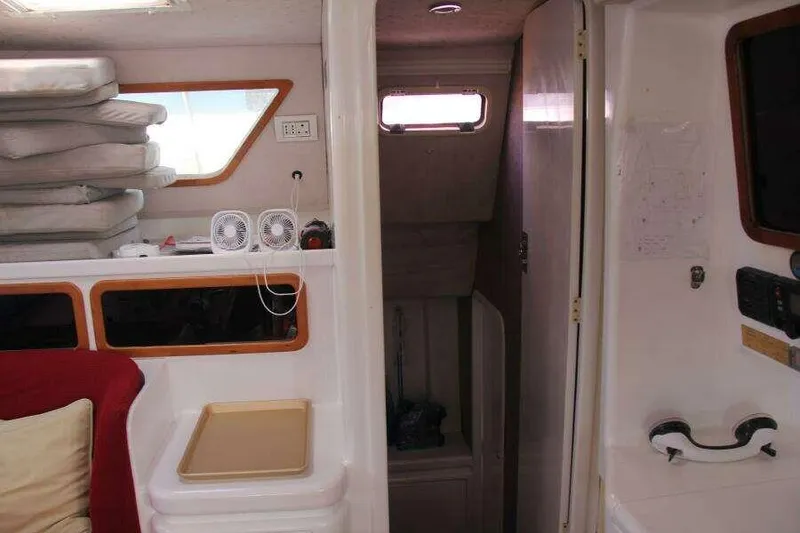 Slide: The Image of Interior of 1995 Voyage Yachts Mayotte, featuring cozy seating and compact storage. - 34
