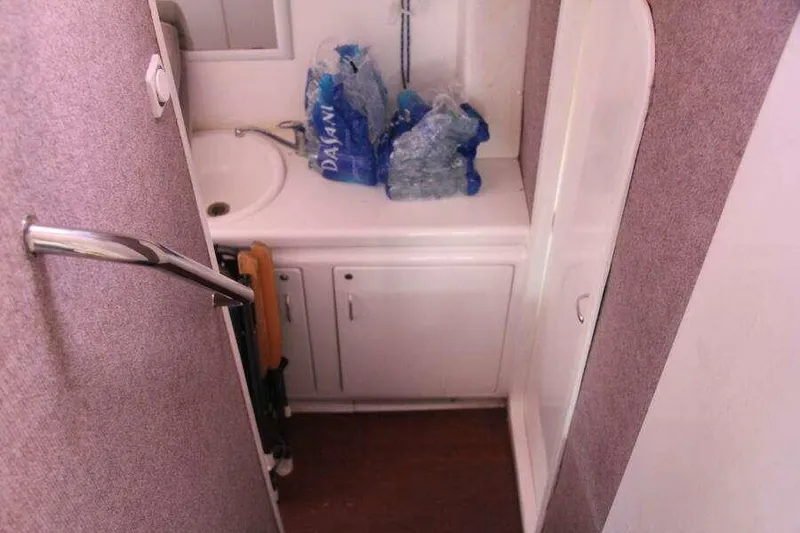 Slide: The Image of Compact bathroom in 1995 Voyage Yachts Mayotte with sink and storage cabinets. - 35