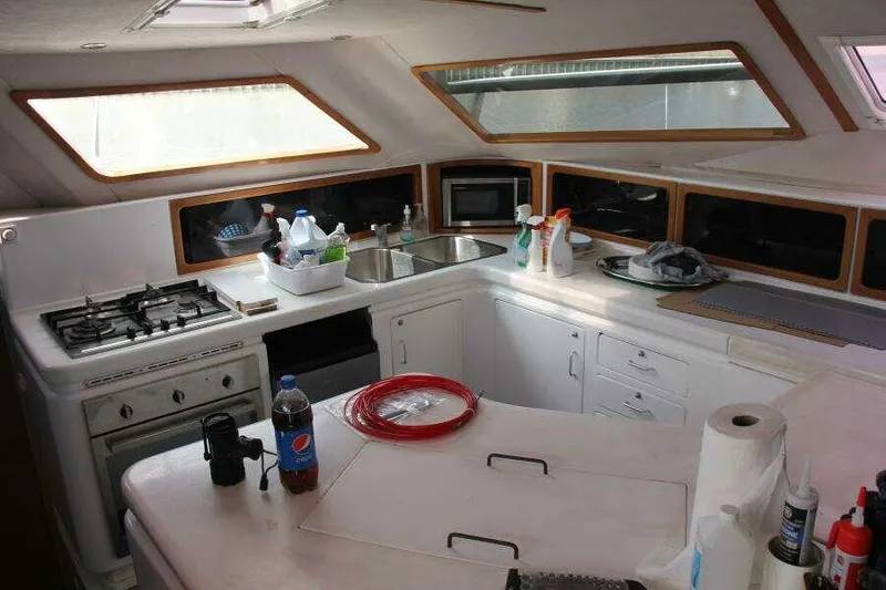 Slide: The Image of Interior of 1995 Voyage Yachts Mayotte kitchen with stove, sink, and storage. - 36