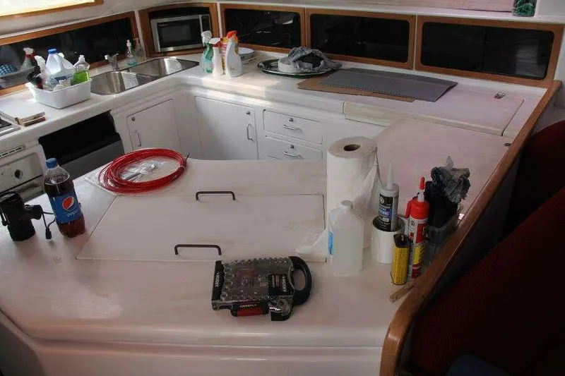 Slide: The Image of Interior of 1995 Voyage Yachts Mayotte kitchen with countertop and various items. - 37