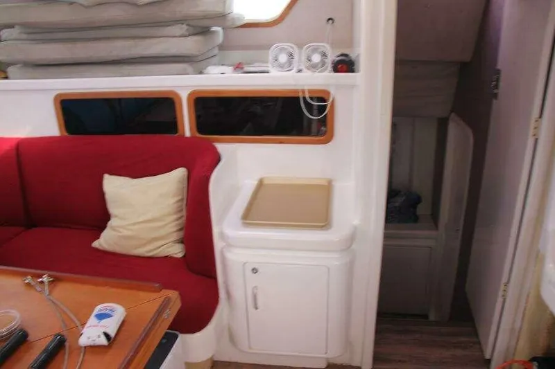 Slide: The Image of Interior of 1995 Voyage Yachts Mayotte with red seating and white cabinetry. - 41