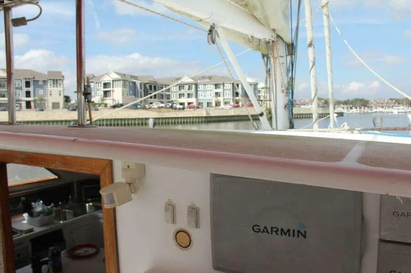 Slide: The Image of 1995 Voyage Yachts Mayotte catamaran with Garmin navigation, docked near waterfront homes. - 44