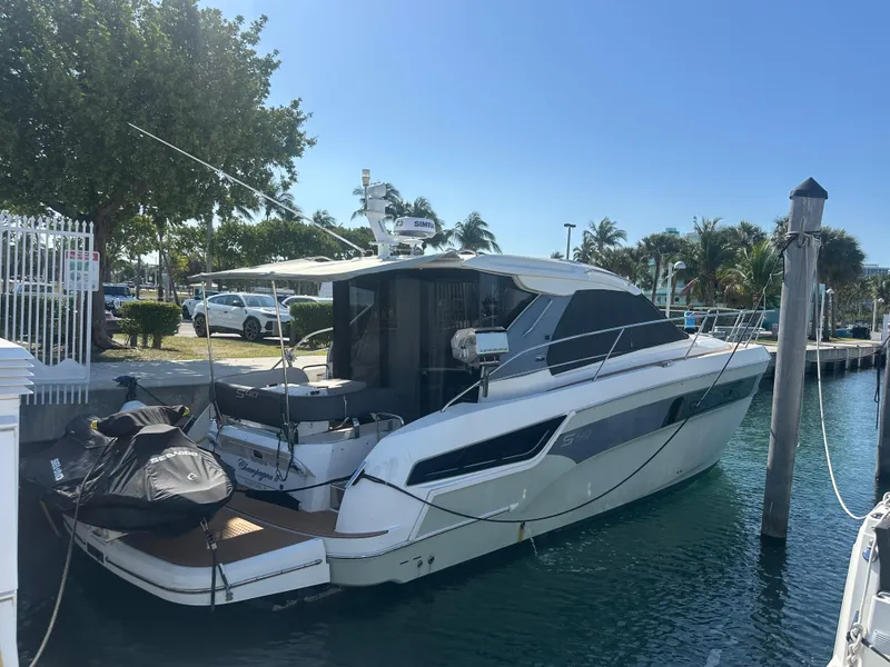 Slide: The Image of 2018 Bavaria S40 Coupe docked at marina, surrounded by clear blue water and lush greenery. - 13