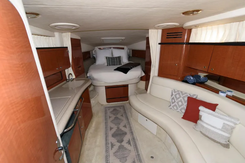 Slide: The Image of Luxurious interior of 2003 Sea Ray 320 Sundancer yacht with cozy seating and bed. - 11