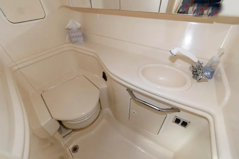 Slide: The Image of 2003 Sea Ray 320 Sundancer bathroom with toilet, sink, and countertop. - 17