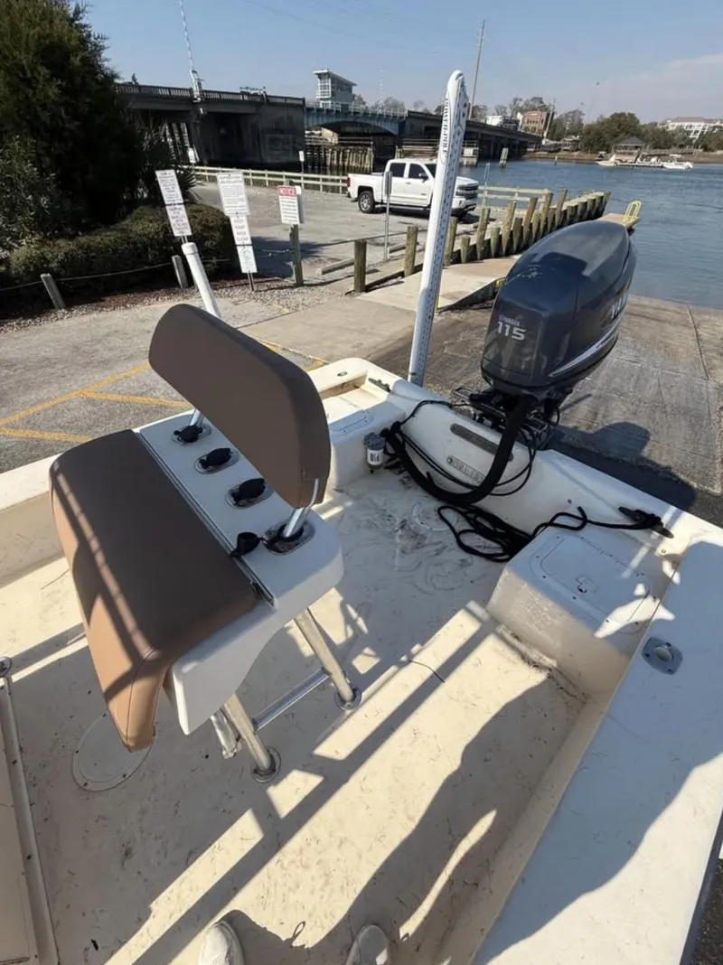 Slide: The Image of 2006 Jones Brothers 23 Bateau boat with Yamaha 115 outboard motor at a dock. - 10