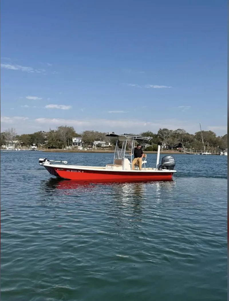 Slide: The Image of 2006 Jones Brothers 23 Bateau boat on calm water, clear sky background. - 5