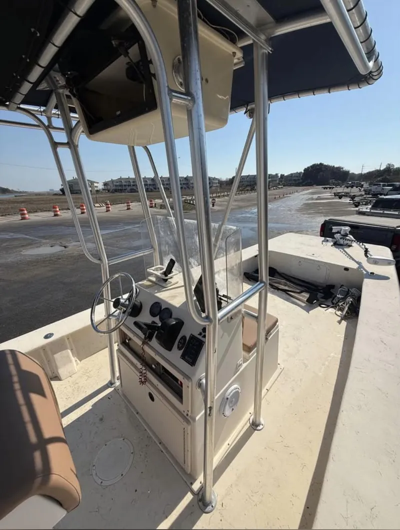Slide: The Image of 2006 Jones Brothers 23 Bateau boat with center console and canopy, docked at marina. - 7