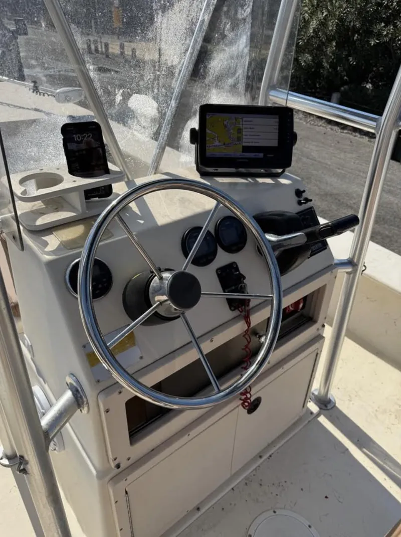 Slide: The Image of 2006 Jones Brothers 23 Bateau boat dashboard with steering wheel and navigation equipment. - 9