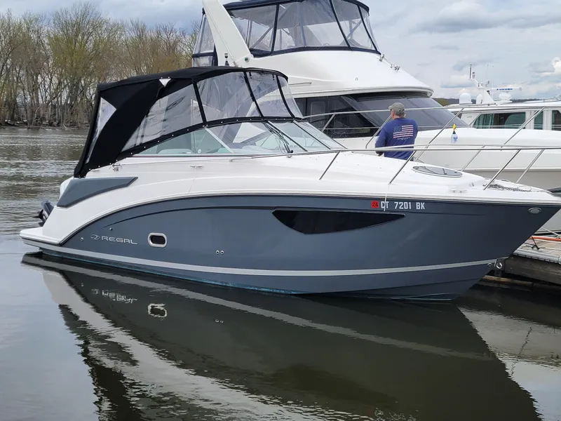 Slide: The Image of 2020 Regal 26 XO boat docked on calm water with canopy. - 0