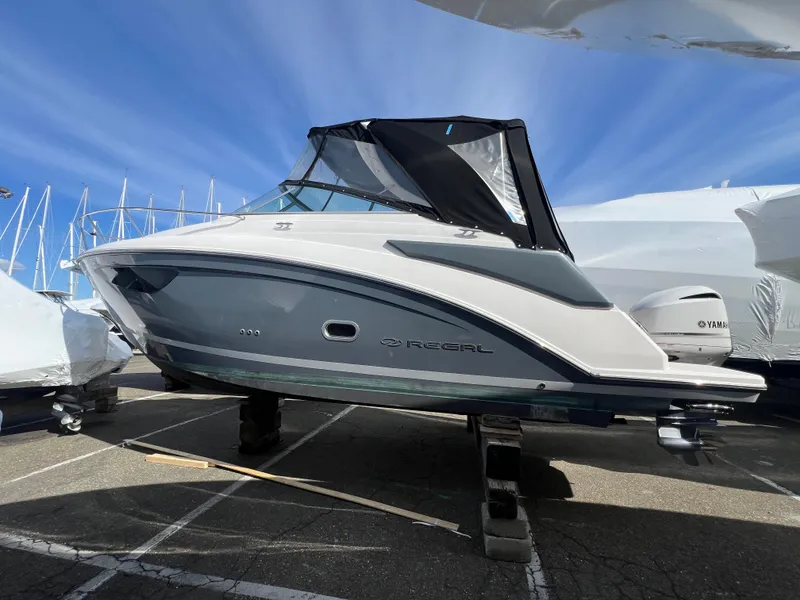 Slide: The Image of 2020 Regal 26 XO boat on display under a clear blue sky. - 1