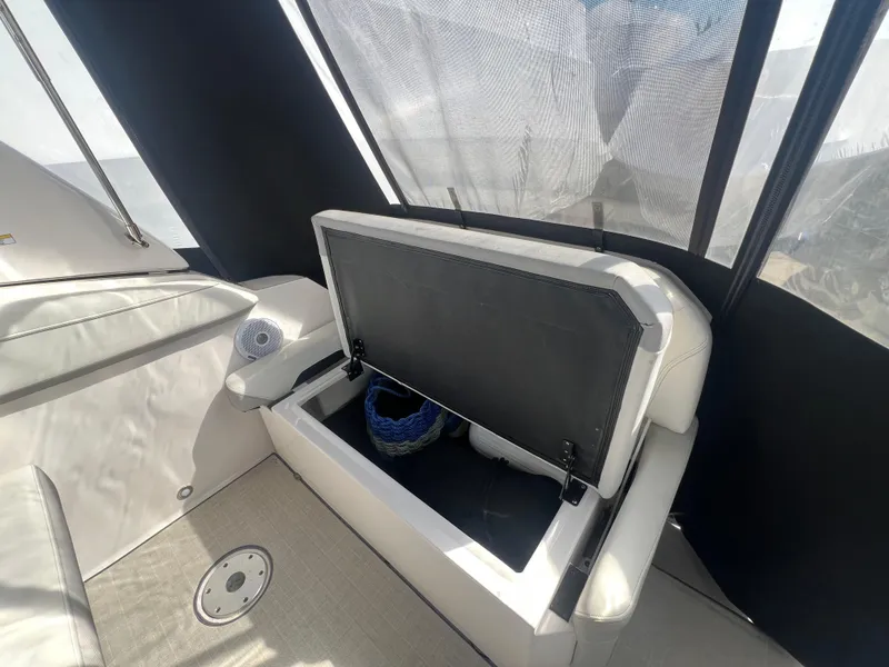 Slide: The Image of 2020 Regal 26 XO boat interior with open storage compartment. - 10