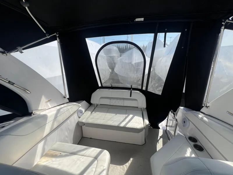 Slide: The Image of 2020 Regal 26 XO boat interior with white seating and black canopy. - 11