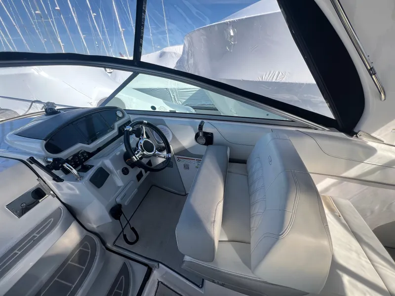 Slide: The Image of 2020 Regal 26 XO boat interior with steering wheel and seating, showcasing modern design. - 18